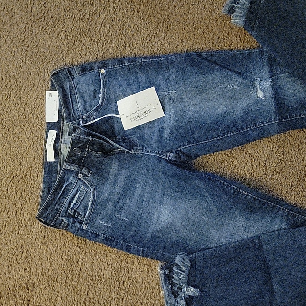 1 pair of Kancan skinny jeans with frayed hem.